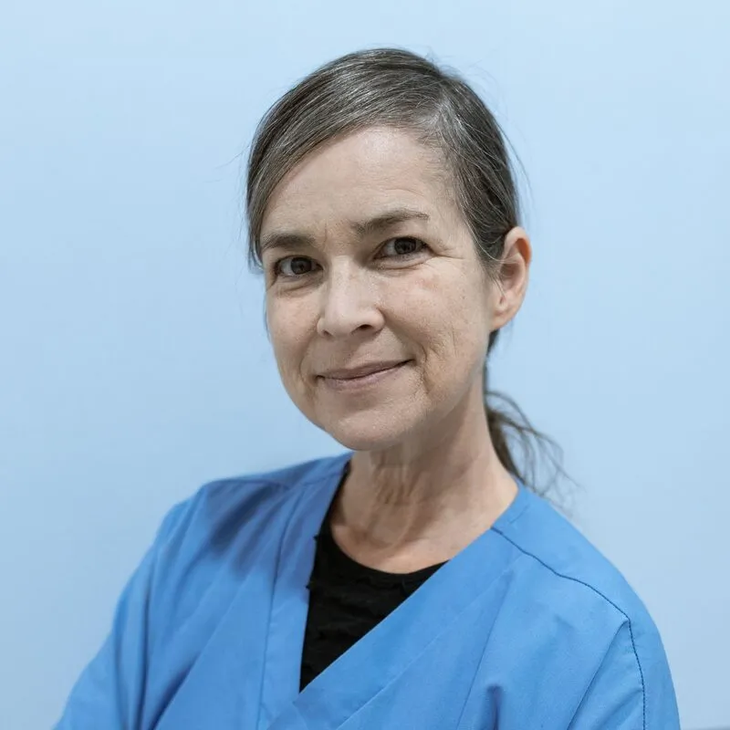 Hannah Wright, dental hygienist, in blue scrubs